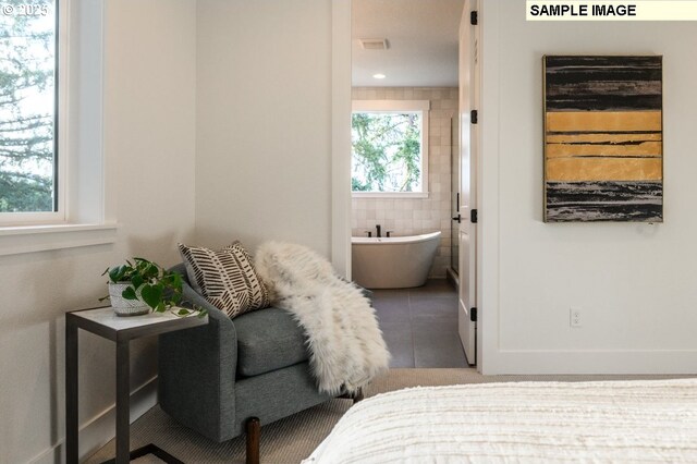 bedroom featuring visible vents, connected bathroom, tile patterned flooring, and tile walls