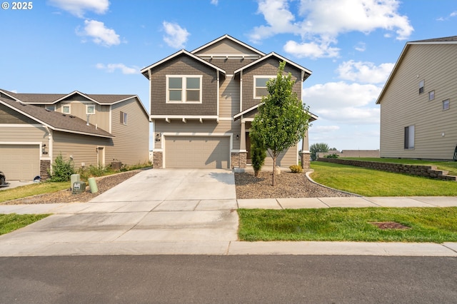 craftsman house featuring a garage, driveway, a front lawn, and stone siding