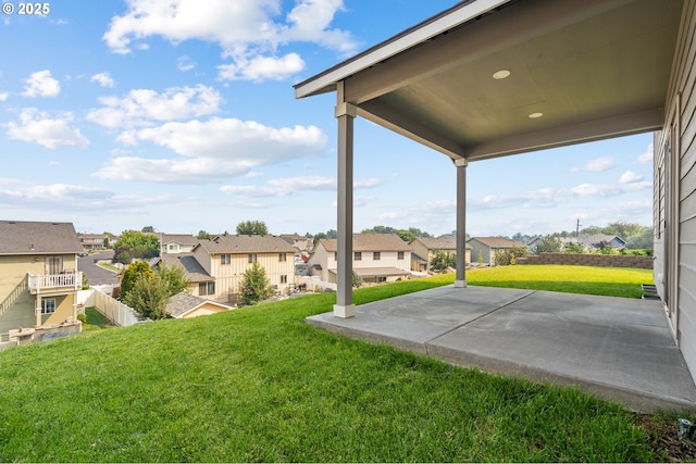 view of yard with a residential view and a patio