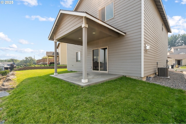 back of house featuring central air condition unit, a patio, and a yard