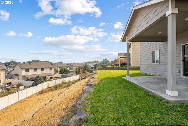 view of yard featuring a residential view, fence, and a patio area