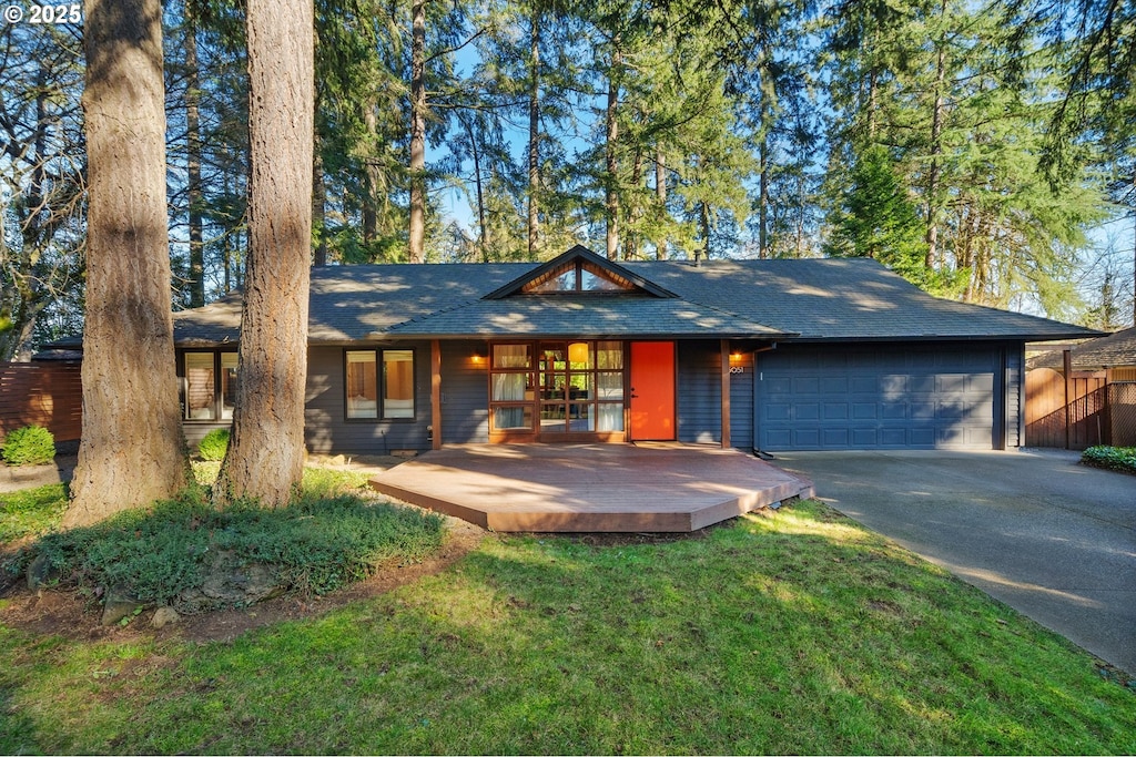 view of front of home featuring a garage and a front lawn