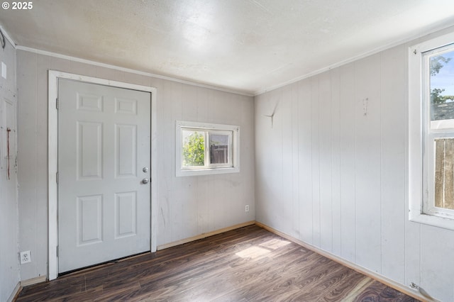 173 N Seneca Rd, Eugene, OR 97402 - foyer entrance featuring wood finished floors, healthy amount of natural light, wood walls, and ornamental molding