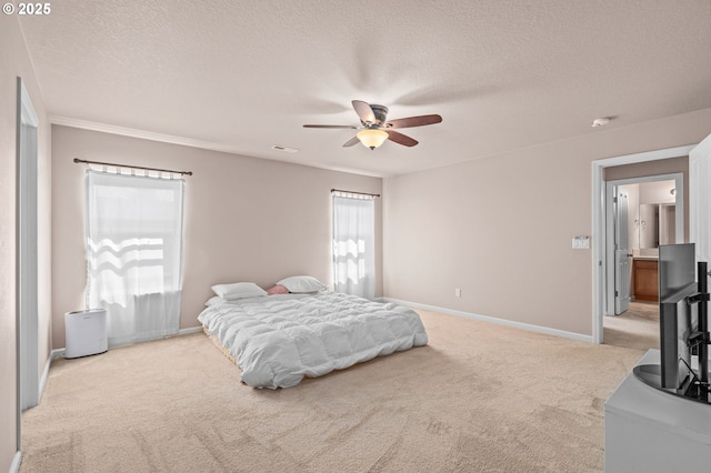 carpeted bedroom with a textured ceiling, baseboards, and a ceiling fan