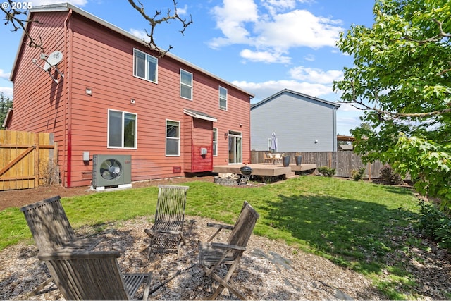 back of house with a cooling unit, a deck, and an outdoor fire pit