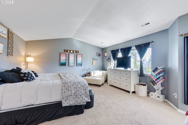 bedroom with visible vents, a textured ceiling, carpet, baseboards, and vaulted ceiling