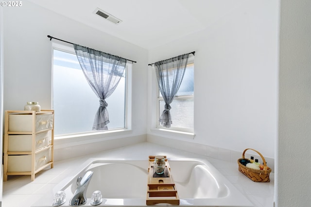 bathroom with visible vents and a garden tub