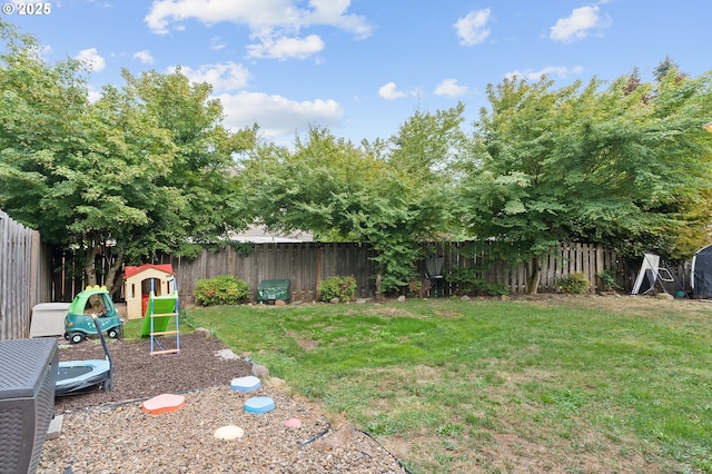 view of yard featuring a playground and a fenced backyard