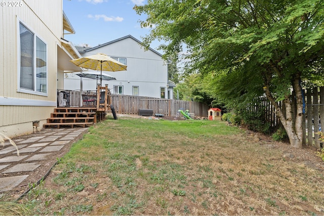 view of yard featuring a deck and a fenced backyard