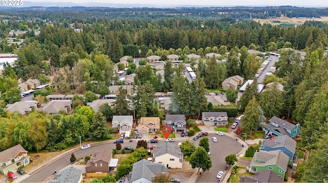 birds eye view of property with a residential view and a wooded view