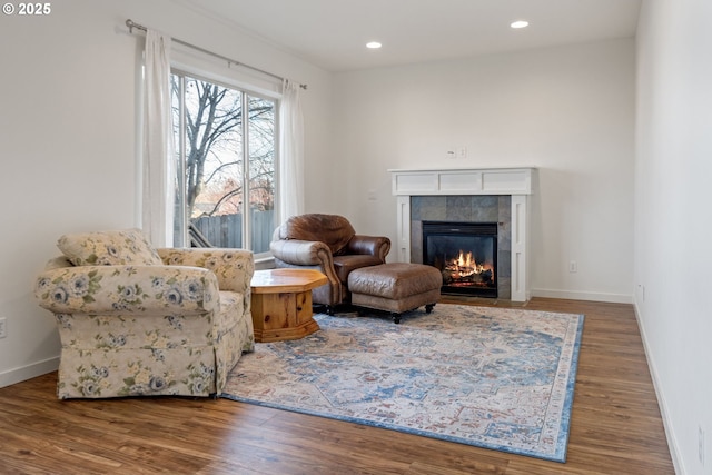 living area featuring hardwood / wood-style flooring and a fireplace