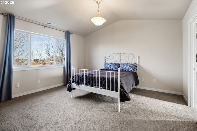 bedroom with carpet floors and vaulted ceiling