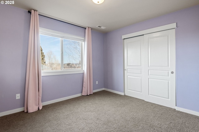 unfurnished bedroom featuring a closet and carpet