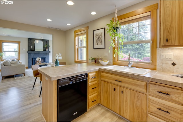 5818 SW Boundary St, Portland, OR 97221 - kitchen with dishwasher, a sink, light wood-style floors, a peninsula, and recessed lighting
