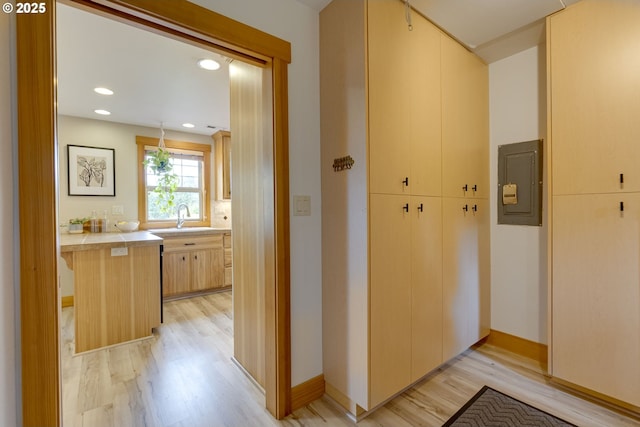 5818 SW Boundary St, Portland, OR 97221 - corridor with electric panel, light wood-type flooring, recessed lighting, a sink, and baseboards