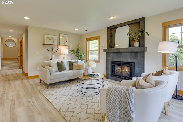 5818 SW Boundary St, Portland, OR 97221 - living area featuring a tiled fireplace, wood finished floors, plenty of natural light, baseboards, and recessed lighting