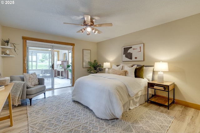 5818 SW Boundary St, Portland, OR 97221 - bedroom with access to outside, light wood-style floors, baseboards, and ceiling fan