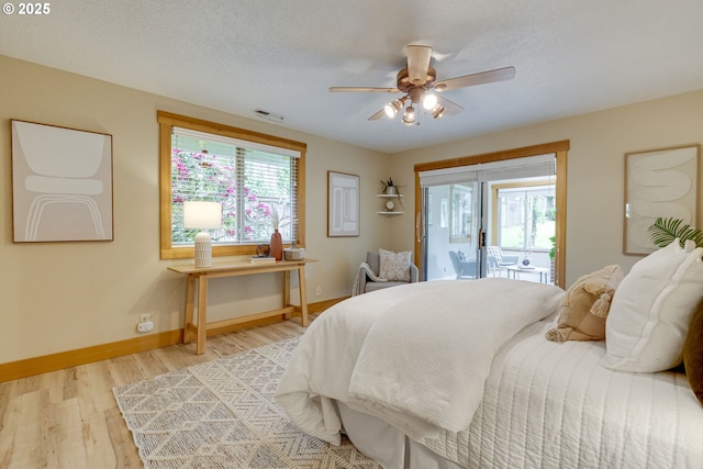 5818 SW Boundary St, Portland, OR 97221 - bedroom featuring access to outside, light wood-style flooring, multiple windows, and baseboards