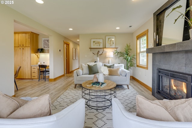 5818 SW Boundary St, Portland, OR 97221 - living room with wood finished floors, a tile fireplace, recessed lighting, and baseboards