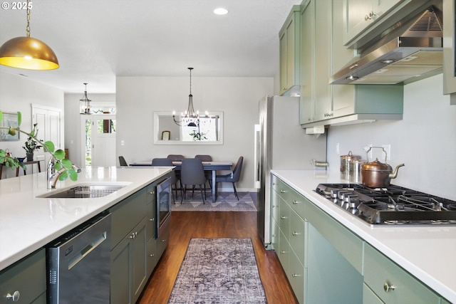 kitchen featuring light countertops, under cabinet range hood, green cabinets, and stainless steel appliances