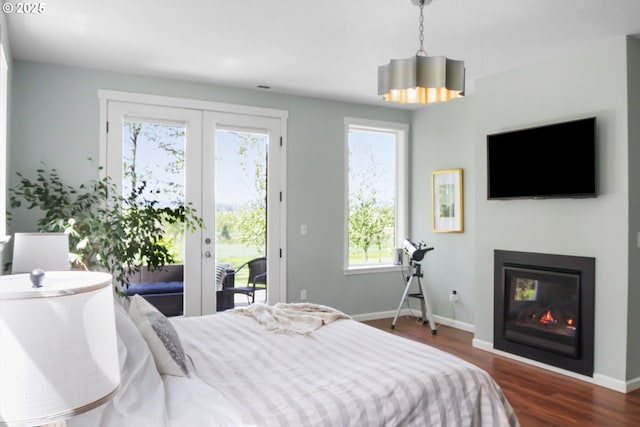 bedroom featuring access to outside, baseboards, dark wood finished floors, and french doors