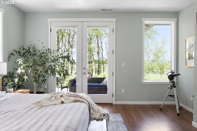 bedroom with multiple windows, access to exterior, french doors, wood finished floors, and visible vents