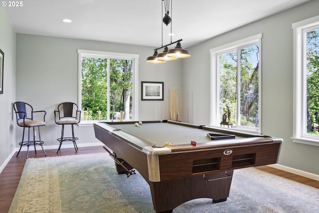 recreation room featuring baseboards, dark wood-type flooring, recessed lighting, and a wealth of natural light