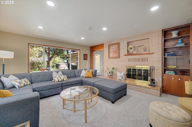 living room with recessed lighting, a textured ceiling, and a fireplace