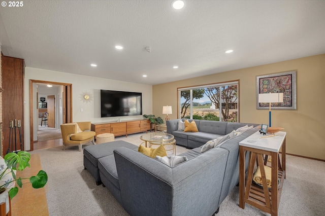living area with recessed lighting and light colored carpet