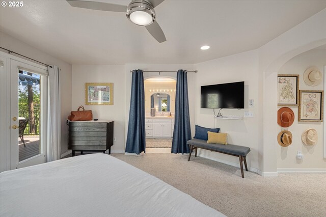 bedroom featuring access to outside, baseboards, ensuite bathroom, and carpet