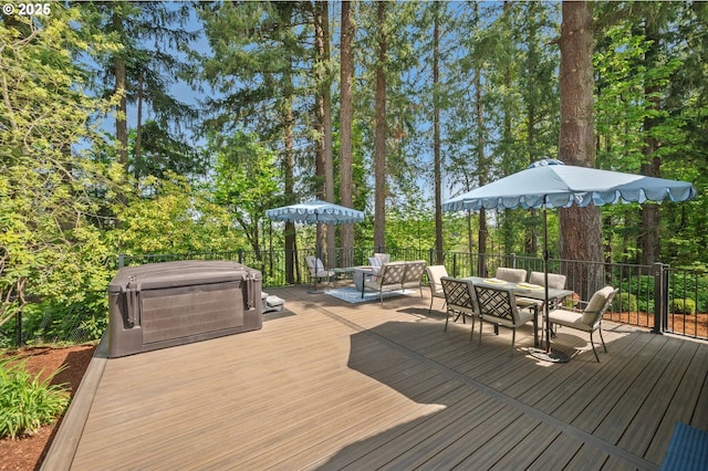 wooden deck featuring outdoor dining area and a hot tub