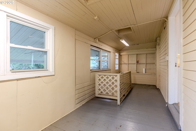 hall featuring wood finished floors and a healthy amount of sunlight