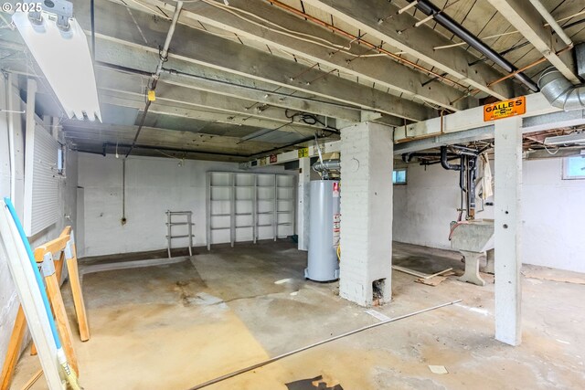 unfinished basement featuring water heater