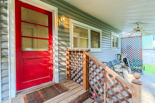 wooden deck featuring a porch and ceiling fan