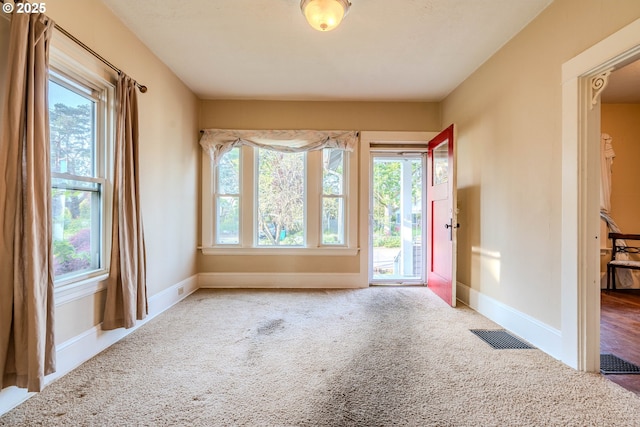 interior space with baseboards, visible vents, and a wealth of natural light