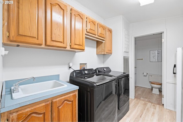 33385 Craig Loop, Cottage Grove, OR 97424 - washroom with separate washer and dryer, light wood finished floors, and cabinet space
