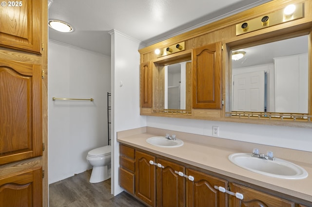 33385 Craig Loop, Cottage Grove, OR 97424 - bathroom featuring double vanity, toilet, wood finished floors, and crown molding