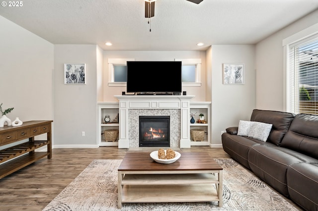 12209 Mimosa Way, Oregon City, OR 97045 - living area featuring wood finished floors, ceiling fan, baseboards, recessed lighting, and a glass covered fireplace