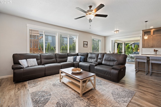 12209 Mimosa Way, Oregon City, OR 97045 - living area with ceiling fan, light wood-style floors, and baseboards