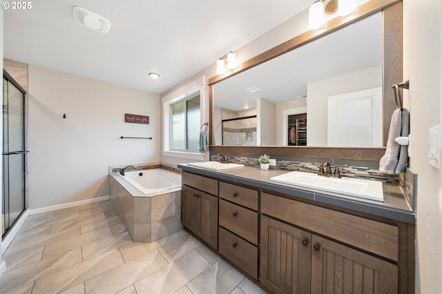 12209 Mimosa Way, Oregon City, OR 97045 - bathroom featuring double vanity, a shower stall, a bath, baseboards, and a walk in closet