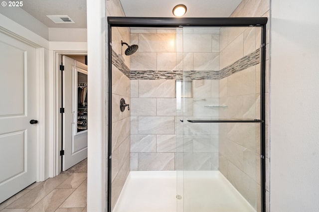 12209 Mimosa Way, Oregon City, OR 97045 - bathroom featuring a stall shower, a spacious closet, and tile patterned flooring