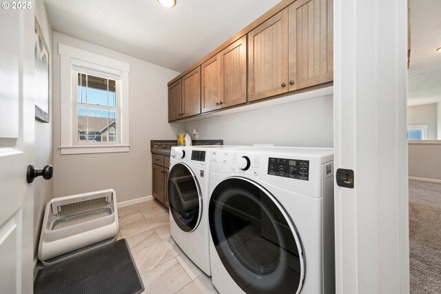 12209 Mimosa Way, Oregon City, OR 97045 - laundry room featuring cabinet space, washing machine and dryer, healthy amount of natural light, and baseboards