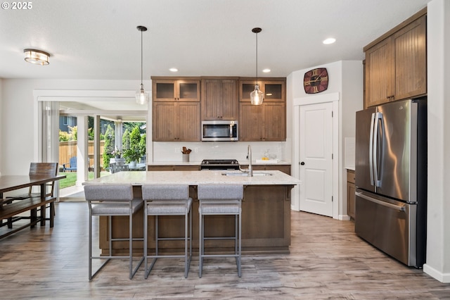 12209 Mimosa Way, Oregon City, OR 97045 - kitchen with appliances with stainless steel finishes, a sink, recessed lighting, backsplash, and wood finished floors