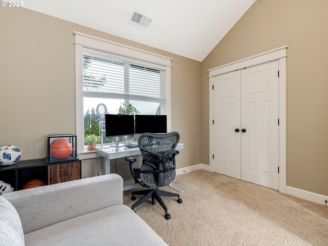 office with lofted ceiling, a wealth of natural light, and carpet flooring