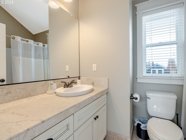 bathroom featuring vanity, a shower with curtain, vaulted ceiling, and toilet