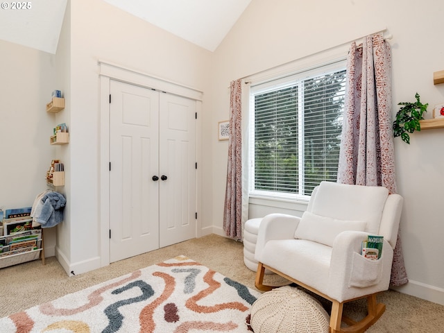 living area with lofted ceiling and light colored carpet