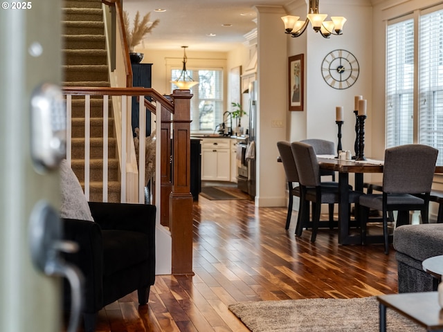 interior space featuring crown molding, dark hardwood / wood-style floors, and a notable chandelier