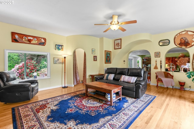 26011 S Morgan Rd, Estacada, OR 97023 - living room with arched walkways, a ceiling fan, wood finished floors, and baseboards