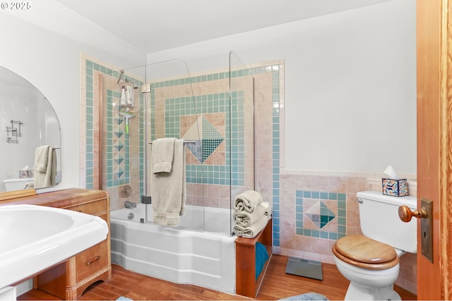 26011 S Morgan Rd, Estacada, OR 97023 - bathroom featuring shower / washtub combination, toilet, wood finished floors, tile walls, and a wainscoted wall