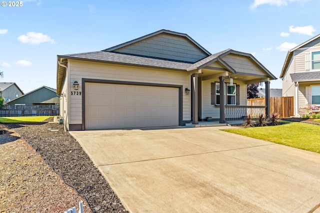5739 Donohoe Ave, Eugene, OR 97402 - view of front of property featuring a porch, an attached garage, driveway, and a shingled roof